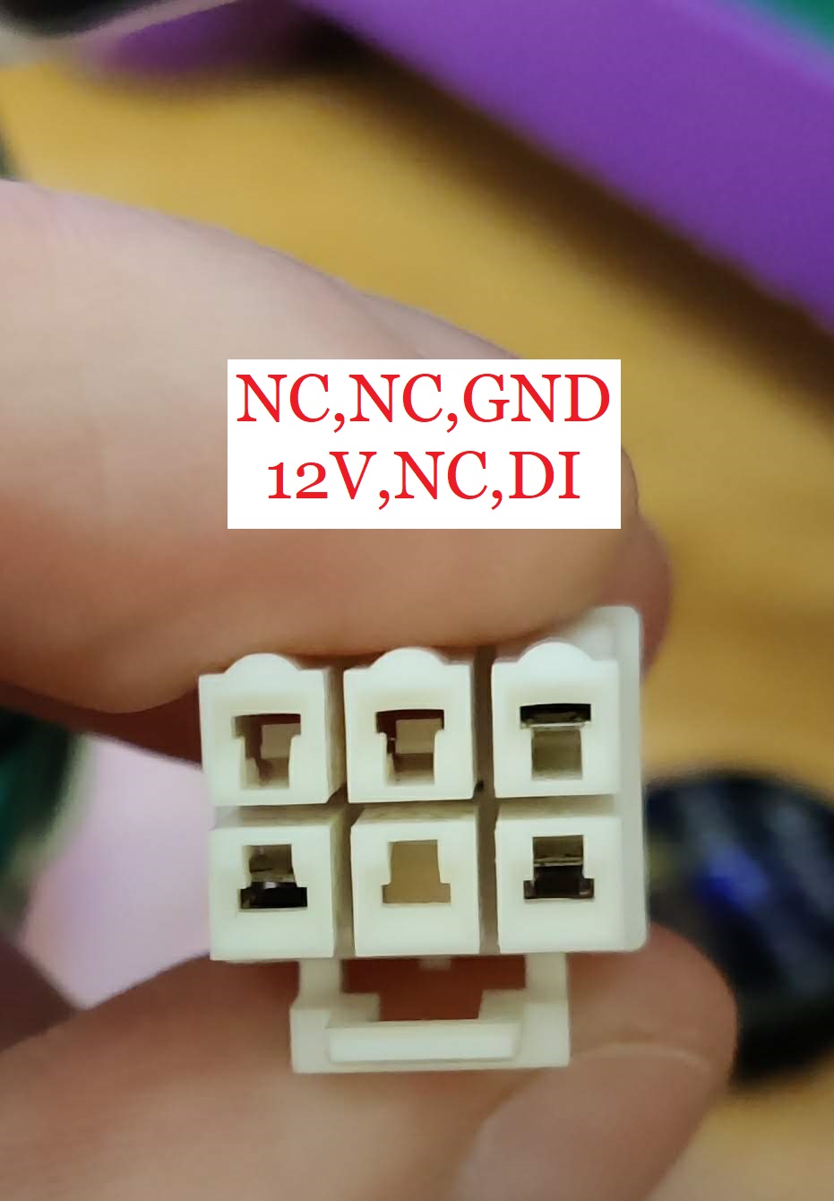 An image showing the LED connector from a chunithm air string unit. The pinout is annotated, left to right, top to bottom, as so: NC, NC, GND, 12V, NC, DI.