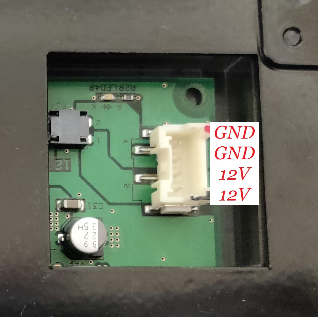 Image showing the rightmost connector on the chunithm arcade slider. The connector is annotated, top to bottom, with the pinouts of GND, GND, 12V, 12V.